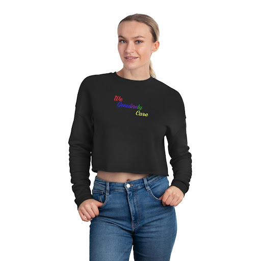 A woman wearing a black sweatshirt with rainbow lettering.