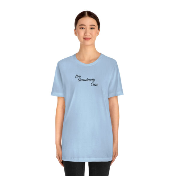 A woman wearing a light blue t-shirt with the word " mommy " written on it.