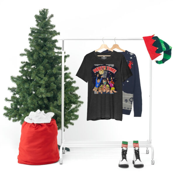 A christmas tree and clothes hanging on a rack.