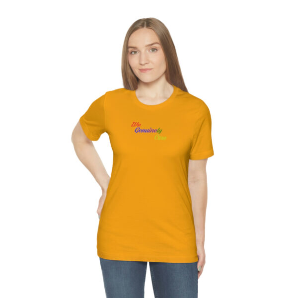 A woman wearing an orange t-shirt with the word " rainbow ".