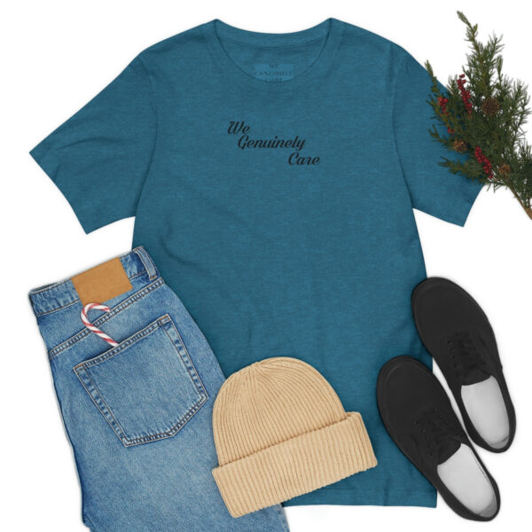 A blue shirt and jeans with shoes, hat and christmas tree.