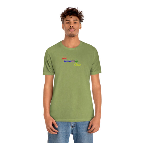 A man wearing a green t-shirt with the word " somewhere " on it.