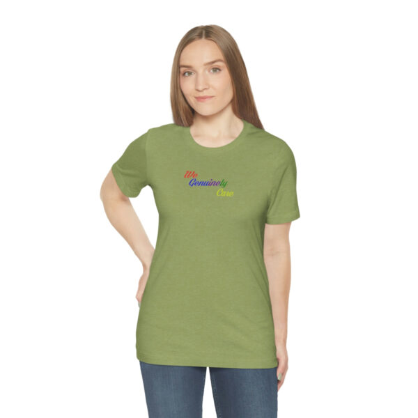 A woman wearing a green t-shirt with the word " rainbow ".