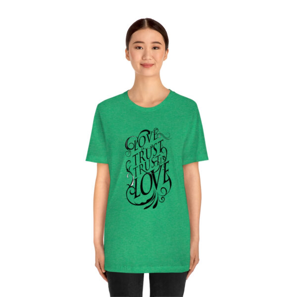 A woman wearing a green t-shirt with the words " go through love ".