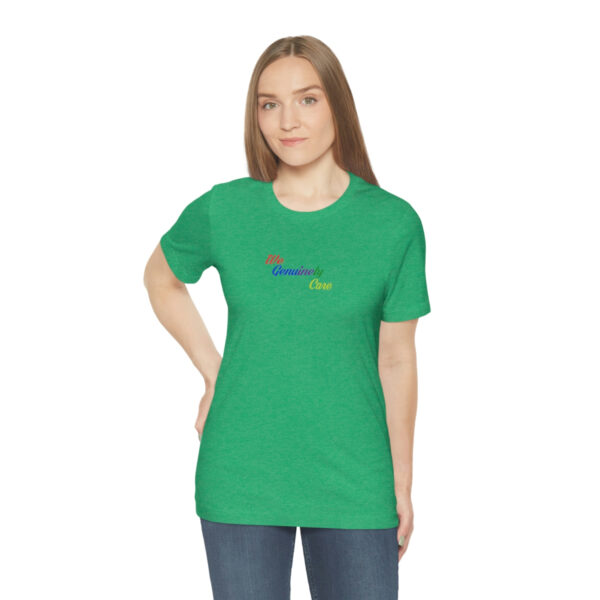 A woman wearing a green shirt with the word " rainbow ".