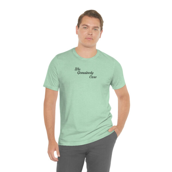 A man wearing a light green t-shirt with the words " my company is " on it.