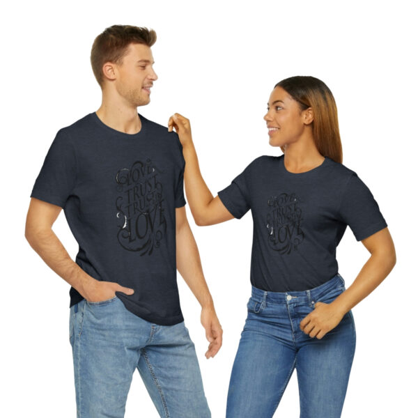 A man and woman holding hands while wearing jeans.