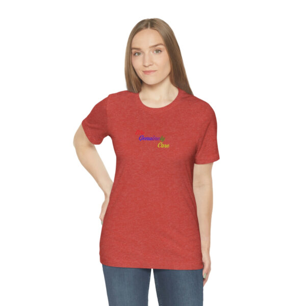 A woman wearing a red shirt with a rainbow logo.