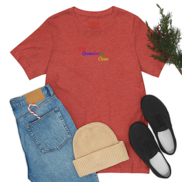 A red shirt and jeans with shoes, hat and plant.