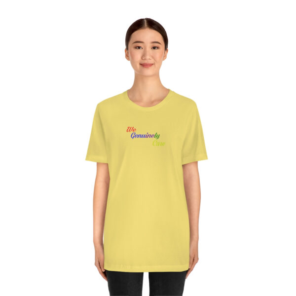 A woman wearing a yellow t-shirt with the word " rainbow ".