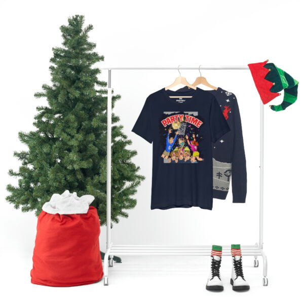 A christmas tree and some clothes hanging on a rack.