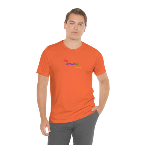 A man wearing an orange t-shirt with the word " rainbow ".