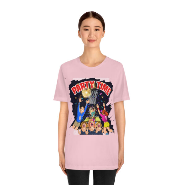 A woman wearing a pink t-shirt with a cartoon of the batman movie.