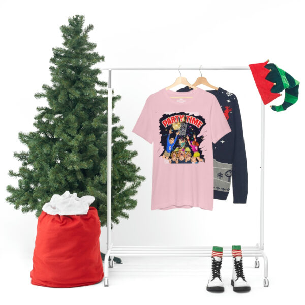 A christmas tree and clothes hanging on a rack.