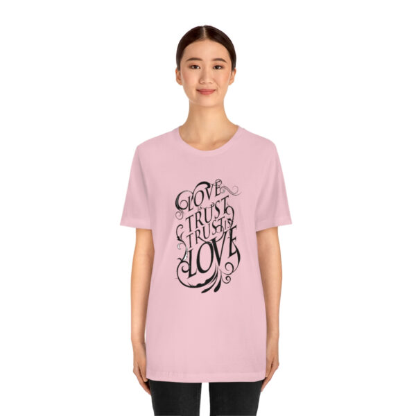 A woman wearing a pink t-shirt with the words " go to sleep in love ".