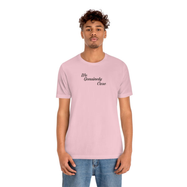 A man wearing a pink t-shirt with the words " sincerely yours ".