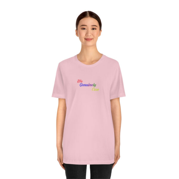 A woman wearing a pink t-shirt with the word " somewhere ".