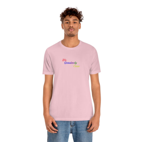 A man wearing a pink t-shirt with the word " somewhere ".