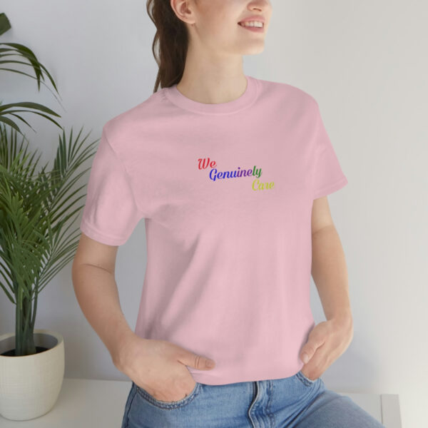 A woman is wearing jeans and a pink shirt