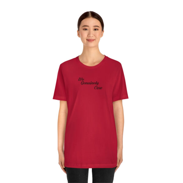 A woman wearing a red t-shirt with the words " be gracious, dear."