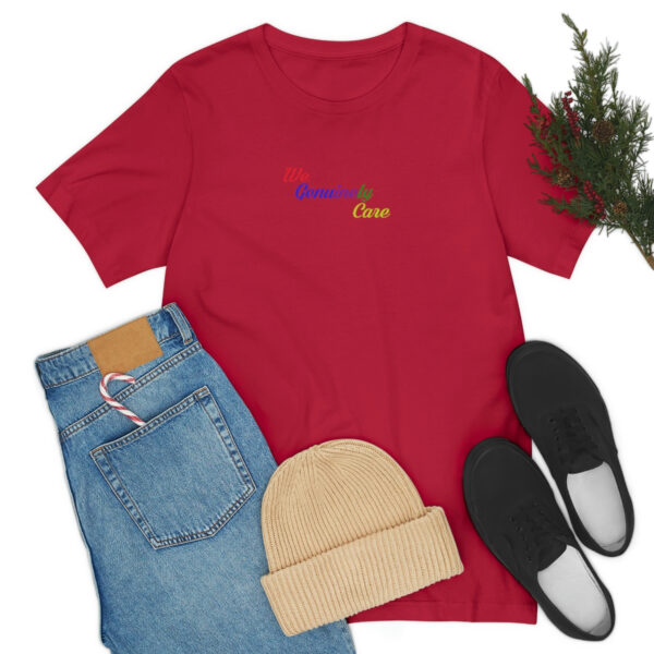 A red shirt and jeans with shoes, a hat and some pine branches.