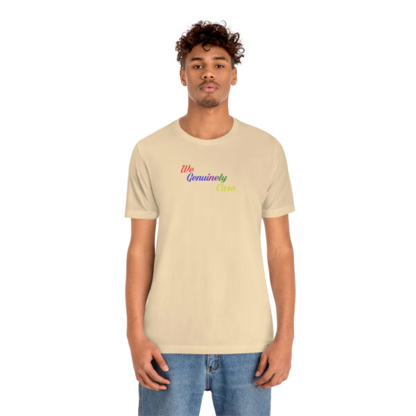 A man wearing a tan t-shirt with the word " rainbow ".