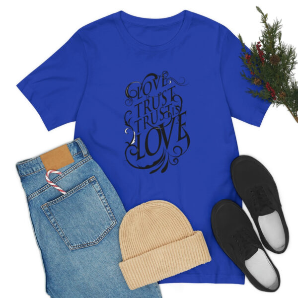 A blue shirt and jeans with shoes, hat and christmas tree.