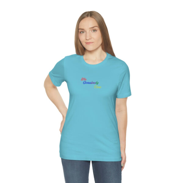 A woman wearing a blue t-shirt with the word " rainbow ".