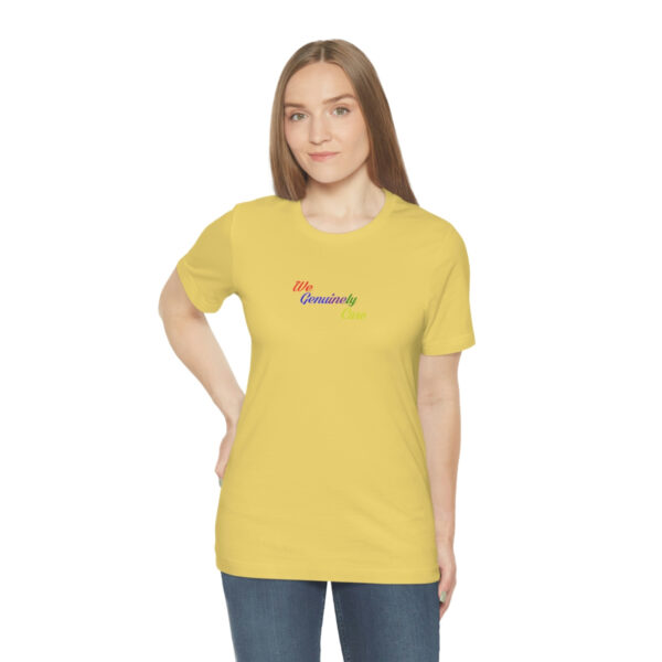 A woman wearing a yellow t-shirt with the word " rainbow ".