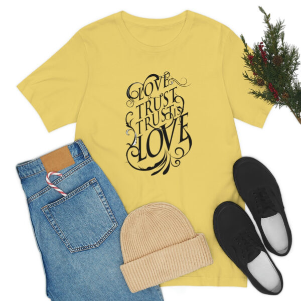 A yellow shirt and jeans with shoes, hat and christmas tree.