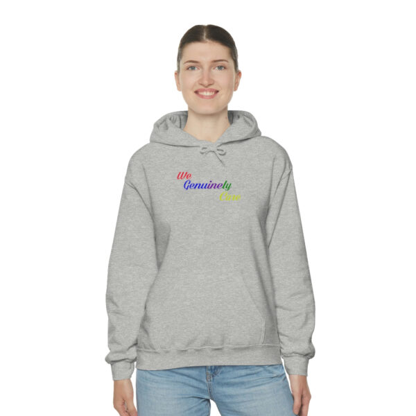 A woman wearing a gray hoodie with the words " my hometown " on it.