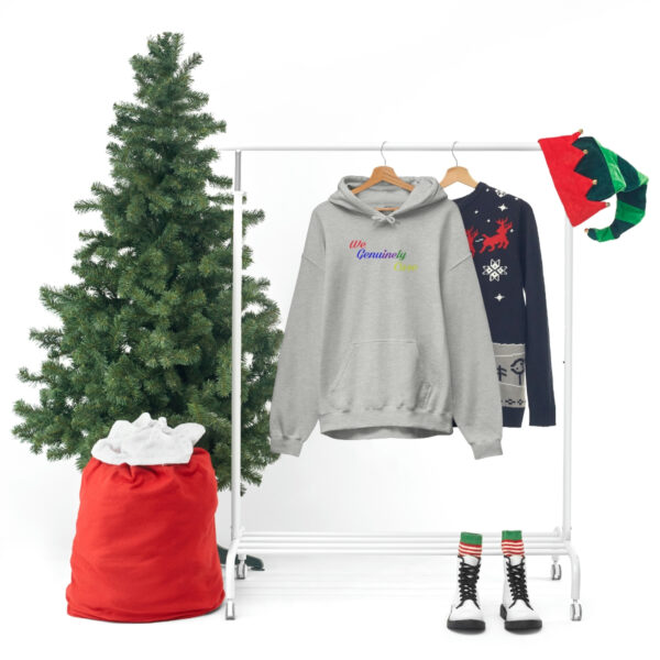 A clothes rack with a christmas tree and some clothing.