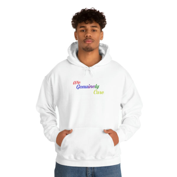 A man in white hoodie with rainbow lettering.