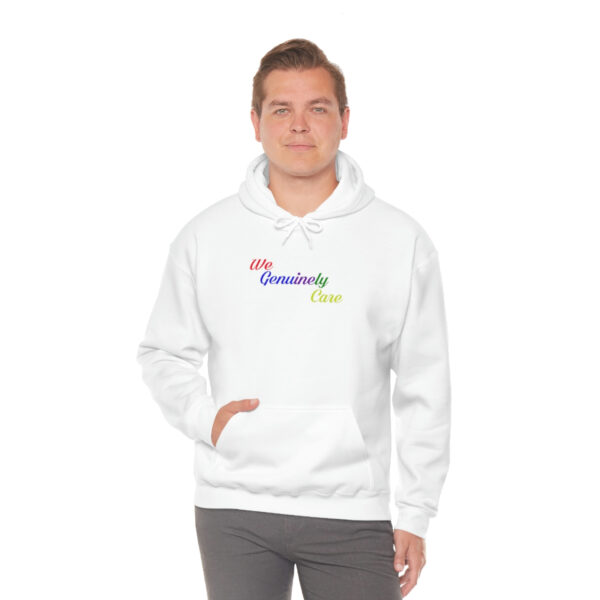 A man in white hoodie with rainbow logo.