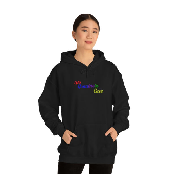 A woman in black hoodie with rainbow lettering.