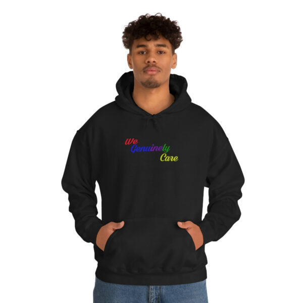 A man in black hoodie with rainbow lettering.