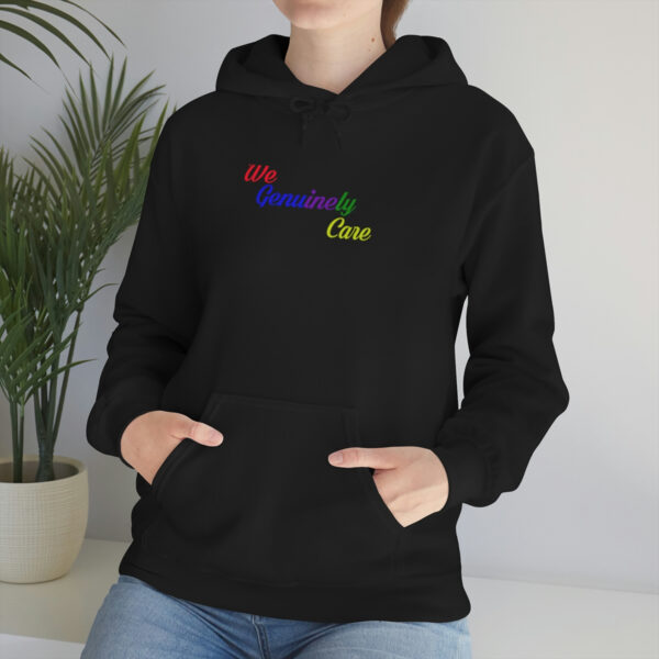 A woman wearing a black hoodie with rainbow lettering.