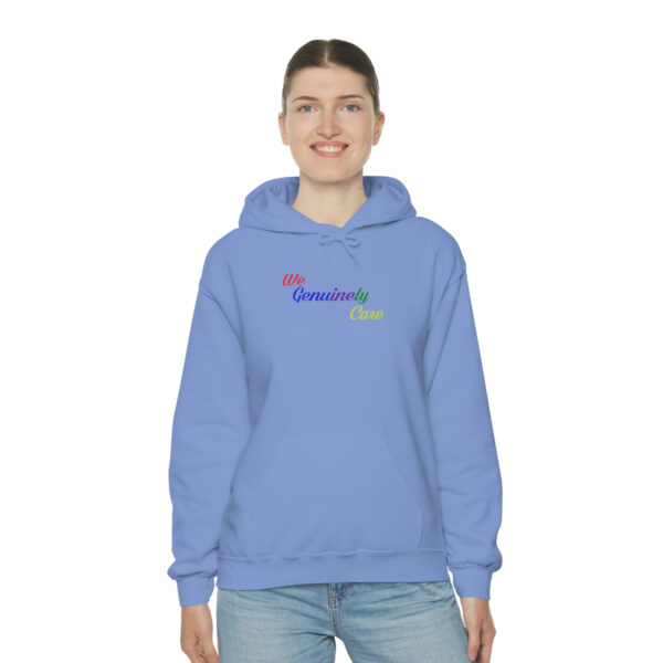 A woman wearing a blue hoodie with the word " rainbow ".