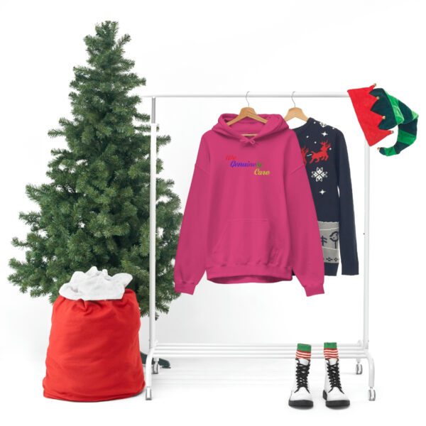 A clothes rack with a christmas tree and some clothing.