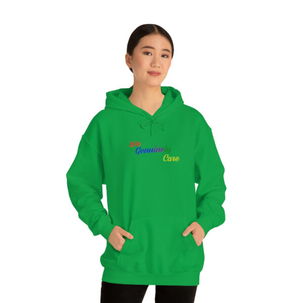 A woman in green hoodie with rainbow logo.