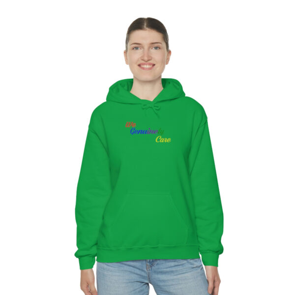 A woman wearing a green hoodie with the word " mom " on it.