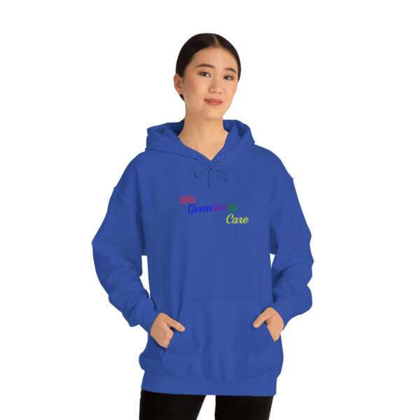 A woman in blue hoodie with rainbow lettering.