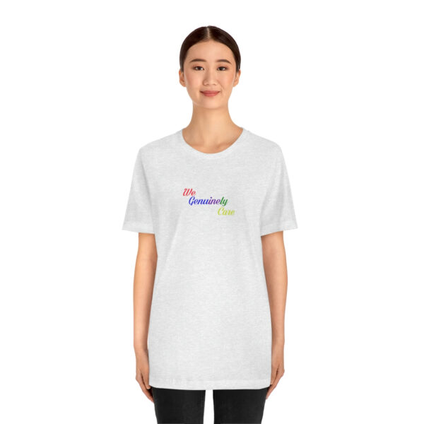 A woman wearing a white t-shirt with the word " democracy " written in rainbow colors.