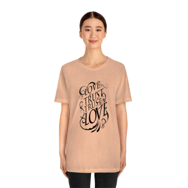 A woman wearing a t-shirt with the words " go to sleep in love ".