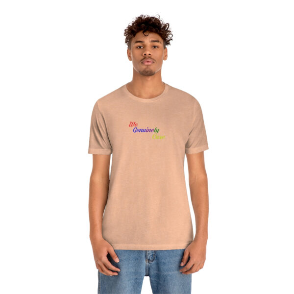 A man wearing a tan t-shirt with the word " rainbow ".