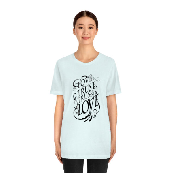 A woman wearing a light blue t-shirt with the words " go to sleep in love ".