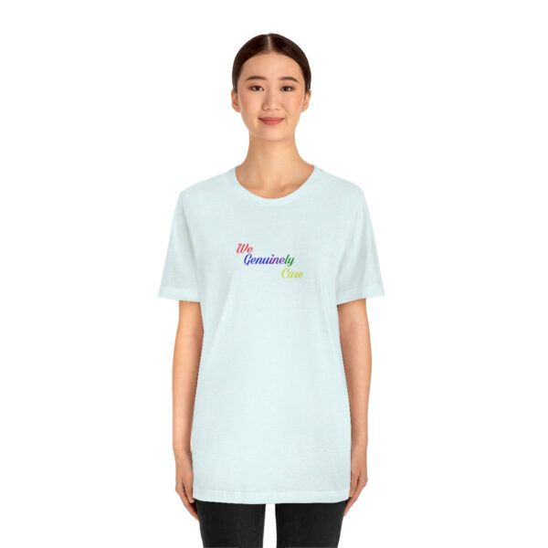 A woman wearing a white t-shirt with the word " rainbow ".