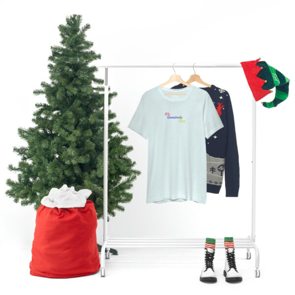 A clothes rack with some shirts and a tree