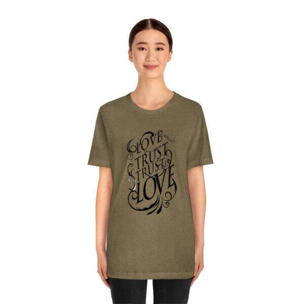 A woman wearing a t-shirt with the words " live laugh love ".