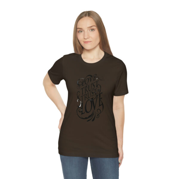 A woman wearing a brown t-shirt with an image of a horse.